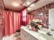 A cozy bathroom featuring dual sinks, unique wallpaper, and bright pink accents at 2109 Star Sapphire Dr, Raleigh, NC 27610