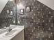 Stylish half-bathroom with modern wallpaper and a sleek vanity at 2109 Star Sapphire Dr, Raleigh, NC 27610