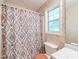 Traditional bathroom showcasing a shower with patterned curtain and wallpaper at 2109 Star Sapphire Dr, Raleigh, NC 27610