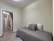 Cozy bedroom featuring a twin bed with a gray plaid coverlet and view to the carpeted stairway at 2109 Star Sapphire Dr, Raleigh, NC 27610