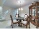 Formal dining area featuring a glass-top table, ornate chairs, and a display cabinet at 2109 Star Sapphire Dr, Raleigh, NC 27610