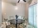 Dining room features a glass table, decorative chairs, and vertical blinds at 2109 Star Sapphire Dr, Raleigh, NC 27610