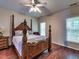 Spacious bedroom with a four-poster bed, hardwood floors, and natural light at 2109 Star Sapphire Dr, Raleigh, NC 27610