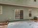 Exterior view of the patio area with sliding glass door and light green siding at 2109 Star Sapphire Dr, Raleigh, NC 27610