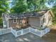 Aerial view of a home with a cozy backyard, including a stone patio and string lights at 211 W Trinity Ave, Durham, NC 27701