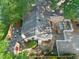 An aerial view showcases a backyard with a stone patio and white picket fence at 211 W Trinity Ave, Durham, NC 27701