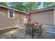 Backyard stone patio featuring an outdoor dining set, seating, and string lights for ambiance at 211 W Trinity Ave, Durham, NC 27701