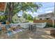 Charming backyard featuring a stone patio, a seating area, and a well-manicured lawn at 211 W Trinity Ave, Durham, NC 27701
