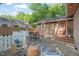 Inviting backyard featuring stone pavers, a seating area, a fenced perimeter, and lush landscaping at 211 W Trinity Ave, Durham, NC 27701