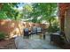 Cozy backyard featuring an outdoor seating area, a fire pit, lush greenery, and string lights at 211 W Trinity Ave, Durham, NC 27701