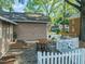 Backyard patio with outdoor seating, a dining area, and a stylish white picket fence at 211 W Trinity Ave, Durham, NC 27701