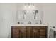 Bathroom featuring a double sink vanity with wood cabinets and white countertops at 211 W Trinity Ave, Durham, NC 27701