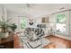 Bright bedroom with hardwood floors, and black and white rug and bedding under a vaulted ceiling at 211 W Trinity Ave, Durham, NC 27701