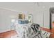 Cozy bedroom with hardwood floors, black and white bedding and area rug and updated lighting at 211 W Trinity Ave, Durham, NC 27701