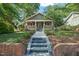 Inviting craftsman-style home with brick accents and a well-manicured lawn on a tree-lined street at 211 W Trinity Ave, Durham, NC 27701