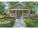 Charming craftsman home with covered front porch, landscaped yard, and inviting curb appeal at 211 W Trinity Ave, Durham, NC 27701