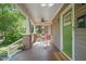 Relaxing front porch with seating, ceiling fan, and a welcoming entrance to the home at 211 W Trinity Ave, Durham, NC 27701