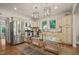 Bright kitchen with stainless steel appliances, cream cabinetry, and a glass-top dining table for a cozy, functional space at 211 W Trinity Ave, Durham, NC 27701