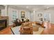 Cozy living room with comfortable furniture, a fireplace, and plenty of natural light at 211 W Trinity Ave, Durham, NC 27701