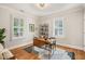 Bright and airy office space with hardwood floors, white walls and window shutters and vintage desk at 211 W Trinity Ave, Durham, NC 27701