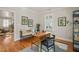 Cozy home office with hardwood floors, comfortable seating, and vintage desk by window with shutters at 211 W Trinity Ave, Durham, NC 27701