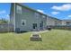 Spacious backyard with green grass, a patio area, and a stone fire pit, offering ample space for outdoor activities at 2123 Scarlet Sage Dr, Durham, NC 27704