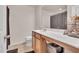 Bright bathroom with a white countertop, a wooden vanity, and a framed mirror at 2123 Scarlet Sage Dr, Durham, NC 27704