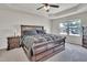 Primary bedroom with tray ceiling, large bed, and ceiling fan at 2123 Scarlet Sage Dr, Durham, NC 27704