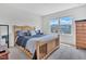 Bedroom with a wooden bed frame, neutral walls, and a window with a view at 2123 Scarlet Sage Dr, Durham, NC 27704
