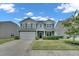 Inviting two-story home with manicured lawn, attached garage, and lovely curb appeal at 2123 Scarlet Sage Dr, Durham, NC 27704