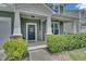 Charming front door with decorative wreath, welcome sign, and stone accents on a two-story home at 2123 Scarlet Sage Dr, Durham, NC 27704