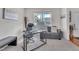 Bright home office featuring a modern glass desk, comfortable seating, and ample natural light at 2123 Scarlet Sage Dr, Durham, NC 27704