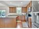 Modern kitchen equipped with stainless steel appliances, granite countertops, and warm wood cabinetry at 2123 Scarlet Sage Dr, Durham, NC 27704