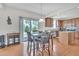 Eat-in kitchen featuring wood floors and modern appliances, perfect for casual dining with backyard access at 2123 Scarlet Sage Dr, Durham, NC 27704