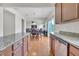 Modern kitchen with granite countertops and wooden cabinets opens to the dining and living areas at 2123 Scarlet Sage Dr, Durham, NC 27704