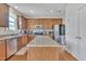 Spacious kitchen features a granite island, stainless steel appliances, and ample wooden cabinetry for storage at 2123 Scarlet Sage Dr, Durham, NC 27704