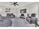 Spacious living room with comfortable seating, a large-screen TV, and modern ceiling fan at 2123 Scarlet Sage Dr, Durham, NC 27704