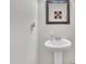 Well-lit powder room featuring a pedestal sink and decorative mirror in a clean and modern design at 2123 Scarlet Sage Dr, Durham, NC 27704