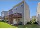 Townhome's back exterior featuring a wood deck overlooking the lawn on a sunny day at 215 Brier Summit Pl, Durham, NC 27703