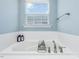 Spa-like bathroom boasts a relaxing soaking tub with elegant fixtures and a window view at 215 Brier Summit Pl, Durham, NC 27703