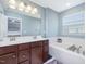 Bright bathroom features double sink vanity, soaking tub, and plenty of natural light at 215 Brier Summit Pl, Durham, NC 27703