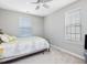 Cozy bedroom with two windows, plush carpeting, and a ceiling fan at 215 Brier Summit Pl, Durham, NC 27703