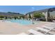 Community pool, with lounge chairs and adjacent buildings with solar panels on the roof at 215 Brier Summit Pl, Durham, NC 27703
