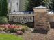 Stone sign that reads, 'West Brier Townes', surrounded by pink flowers and mulch at 215 Brier Summit Pl, Durham, NC 27703