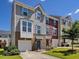 Charming townhome with well-maintained lawn, attached garage, and brick accents at 215 Brier Summit Pl, Durham, NC 27703