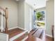 Inviting foyer with hardwood floors, staircase, and an open doorway at 215 Brier Summit Pl, Durham, NC 27703