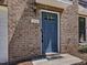View of front door with brick surround and address number 215 at 215 Brier Summit Pl, Durham, NC 27703