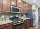 Well-equipped kitchen featuring stainless steel appliances and backsplash at 215 Brier Summit Pl, Durham, NC 27703