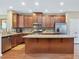 A kitchen with wood cabinets, granite countertops, a stainless refrigerator, and hardwood floors at 215 Brier Summit Pl, Durham, NC 27703