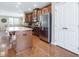 Spacious kitchen with central island, stainless appliances and wood floors at 215 Brier Summit Pl, Durham, NC 27703